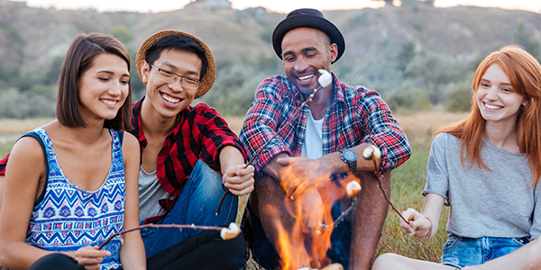 Friends Roasting Marshmallows Over a Fire